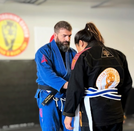 An image of a female student at Easton Littleton being promoted in Brazilian Jiu-Jitsu